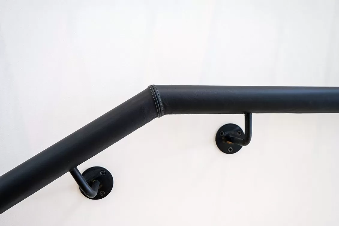 Leather clad handrail for fit out stair by Spiral UK
