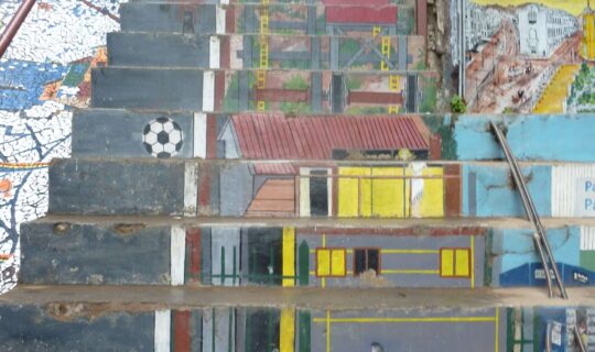 Concrete stairs with images of children playing football painted onto them
