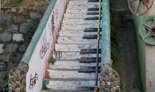 Concrete staircase painted to look like each step is a key on a piano