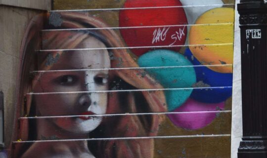 Portrait of a girl with balloons painted on a concrete staircase