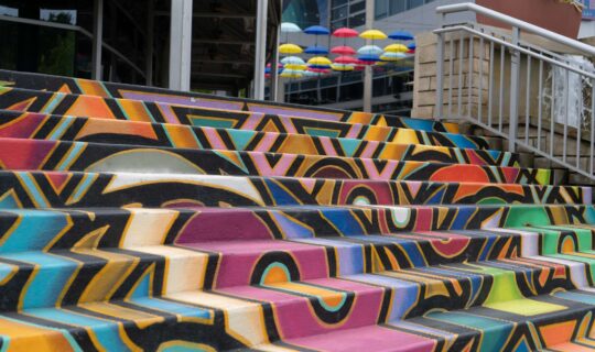 Outdoor steps painted with bright colours in an abstract pattern